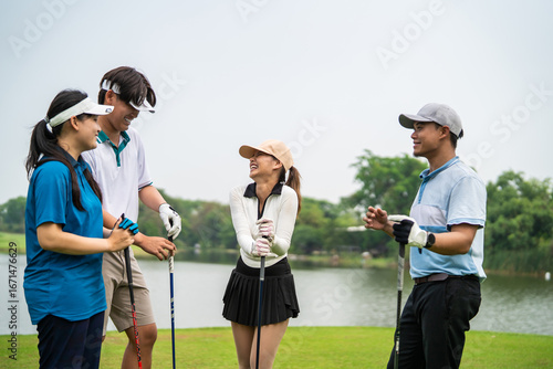 Obraz na plátně Group of young pro golfers holding golf club while stand on green fairway