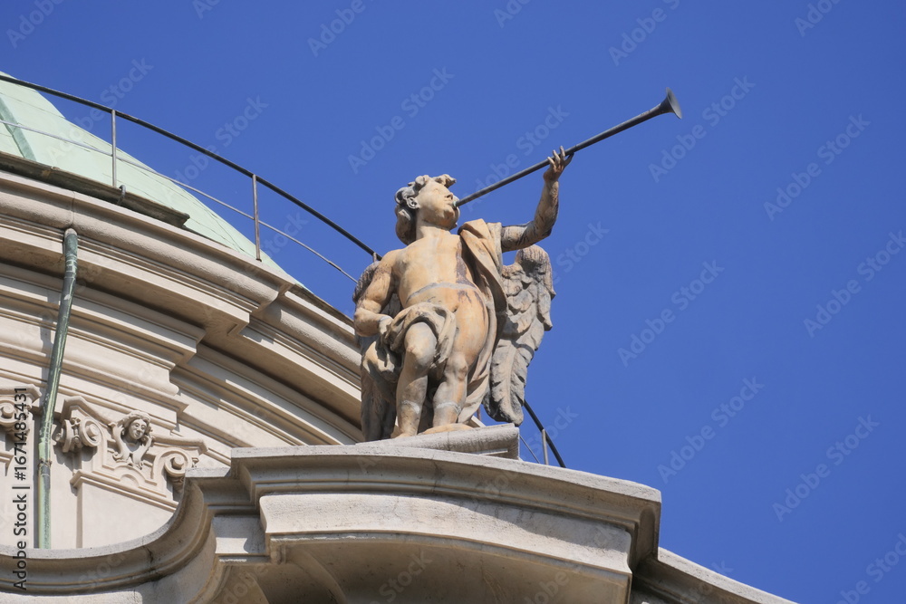 Fototapeta premium Sculpture with trumpet on sant' Alessandro Zebedia basilic in Milan, Lombardy, Italy