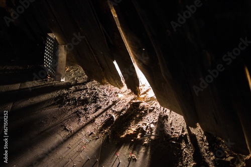 Dusty Attic Interior with Sunbeams. A Glimpse into Old Architecture and Neglected Spaces.