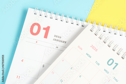 January 2026 calendars close-up on yellow and blue background, planning concept.