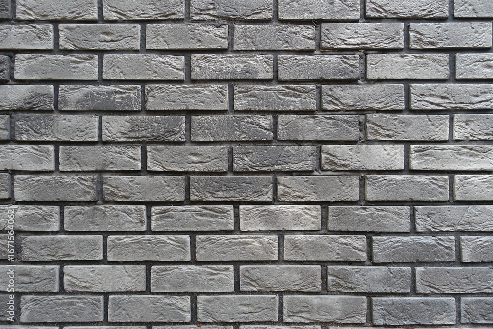 Obraz premium Background - brick veneer wall with stretcher bond pattern in shades of gray