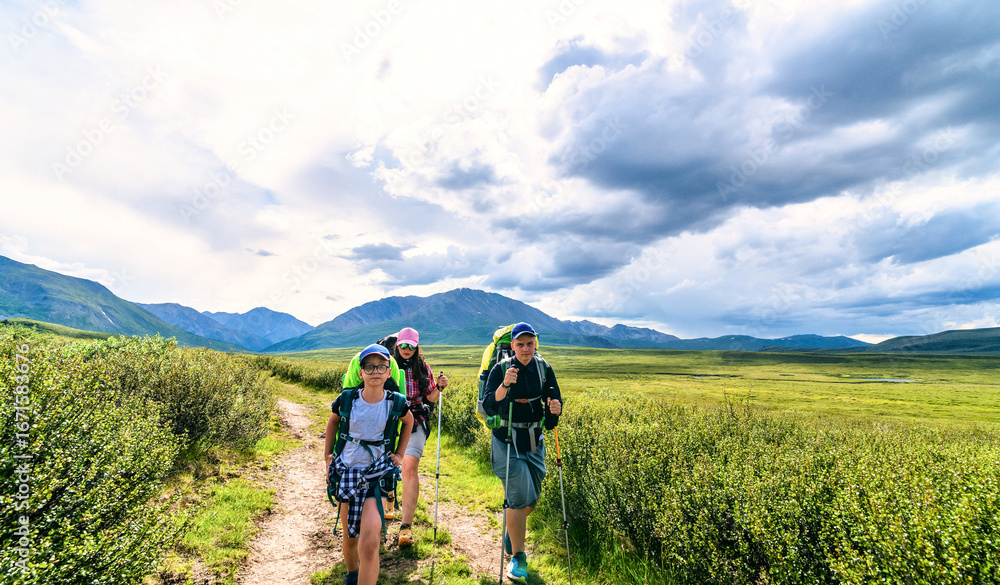 Obraz premium Multi day family trek. Escaping to mountains for family vacation is perfect getaway. The enjoy of the wild and the fresh air is necessary for families on-the-go lifestyle.