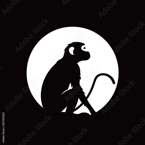 A silhouette of a monkey is positioned beside a full moon, creating a striking contrast against the dark sky. The monkey is in a relaxed pose, exuding a calm demeanor.