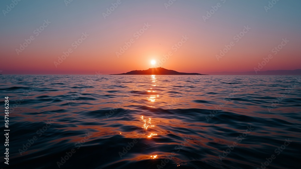 Fototapeta premium Sunset over calm ocean waters with distant island at twilight in serene atmosphere
