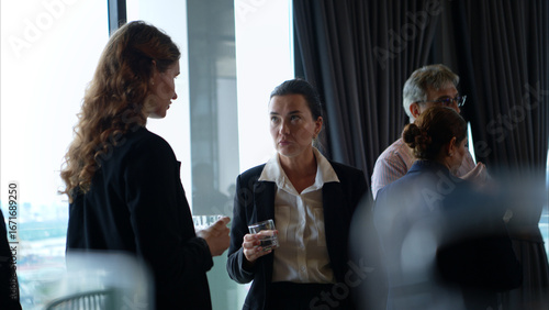 Business professionals networking and enjoying drinks at a corporate event