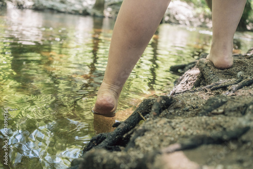 Woman entering river with swollen ankles from lipedema condition