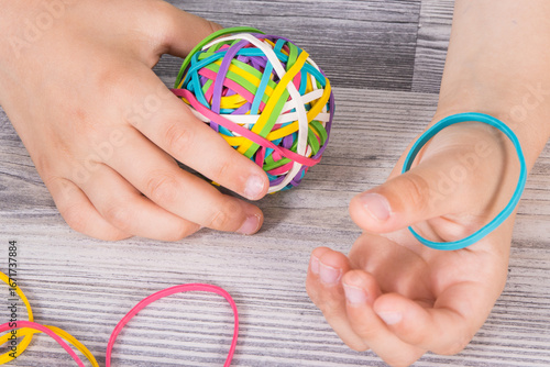 Wallpaper Mural Preschooler hands with ball of rubber bands or erasers. Development of kids motor skills, coordination logical thinking Torontodigital.ca