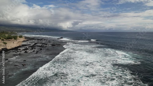 Drone View of Hawaiian Coastline with Passing Boat and Breaking Waves