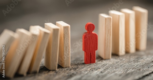 A red figure stands before falling dominoes, symbolizing resilience & choice