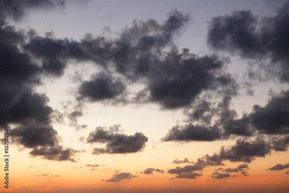 Fototapeta premium The vibrant blue vanilla hues of the sky are perfectly contrasted by the textured white and shadowy dark clouds.