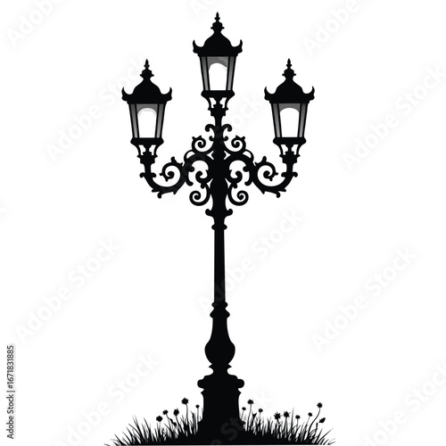 Ornate triple headed black lamppost silhouette with grass and flowers