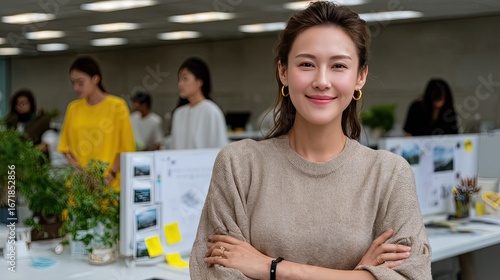 Confident Businesswoman in the Office: A confident businesswoman exudes poise and determination, her arms crossed as she looks directly at the viewer in a brightly lit office setting.