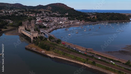 Wallpaper Mural Aerial video of Conwy Castle, railway line, and road bridge crossing the estuary with the town and mountains in the background on a summer day.
 Torontodigital.ca
