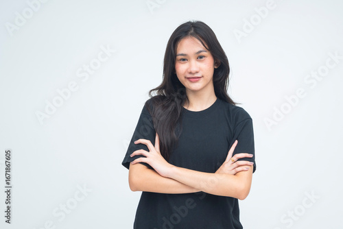 Canvastavla A strong young Asian woman posing with her arm folded, giving a fierce and smug smirk while locking eyes with the camera