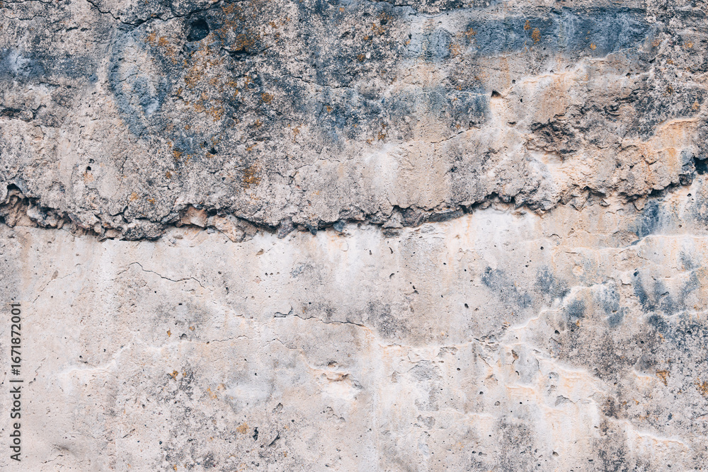 Naklejka premium A fragment of the rough texture of an old concrete surface with cracks, stains and layers of weathered material. Gray-beige shade, pronounced relief and wear. Texture of a concrete wall.