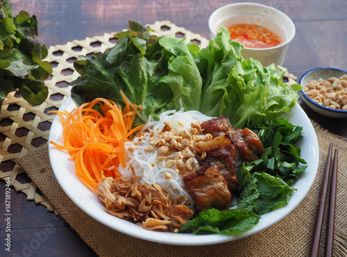 Bun Thit Nuong - Vietnamese grilled pork on vermicelli and vegetables top with peanuts at close up view