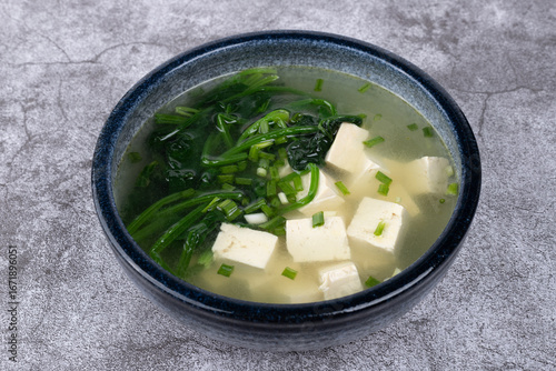 Spinach and tofu soup in a porcelain bowl