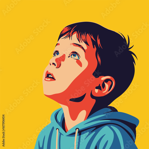 Boy looking up with curious eyes and bright expression against yellow backdrop. Boy looking up in wonder, wearing blue hooded top, illuminated by unseen light.