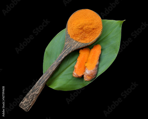 Turmeric powder and turmeric root isolated on black backgroung ,turmeric is herb for help.
