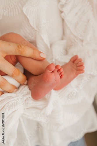 newborn baby feet in mothers hands