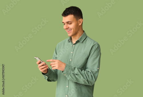 Smiling young man using sma...