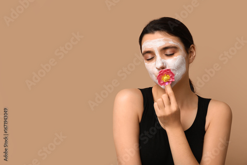 Young woman with facial mas...