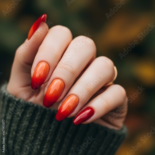 Stunning ombre nails blend fiery red and warm orange, perfect for autumn fashion inspiration