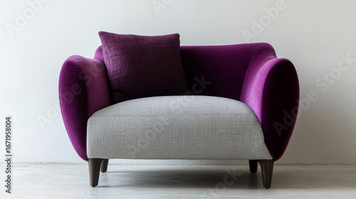 A minimalist armchair with contrasting upholstery: a deep plum backrest and pale gray seat cushion.