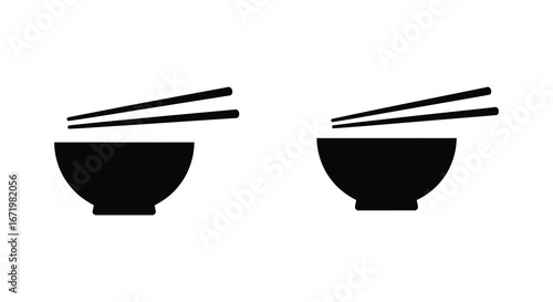 Two black bowls with chopsticks on a white background