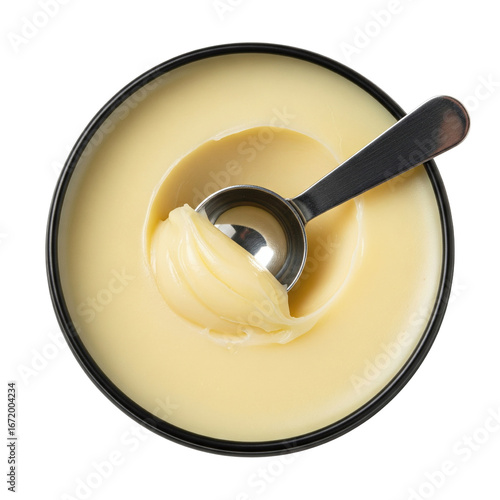 Yellow cosmetic balm or ghee in black bowl