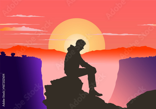 Silholuette of a man sitting on a cliff hugging his knees