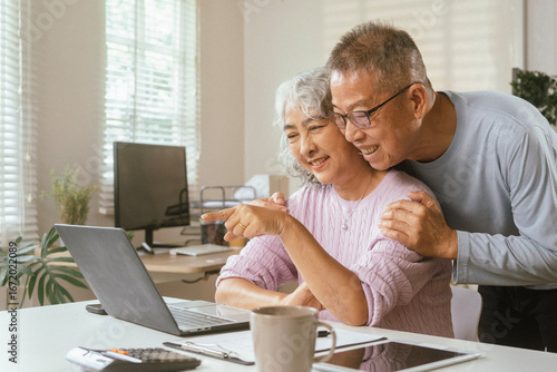 senior couple and documents with laptop for finance, budget planning or retirement annuity on sofa. Elderly man, woman or house with smile, computer or paperwork for pension fund or insurance