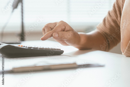 senior couple and documents with laptop for finance, budget planning or retirement annuity on sofa. Elderly man, woman or house with smile, computer or paperwork for pension fund or insurance