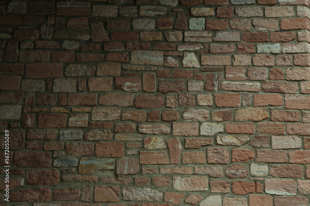 Fototapeta premium Textured sandstone brick masonry wall surface