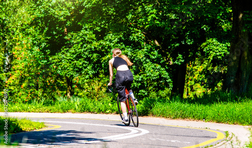 Wallpaper Mural Cyclist ride on the bike path in the city Park
 Torontodigital.ca