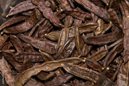 Dried Carob Pods Arranged in a Pile for Natural Health Benefits