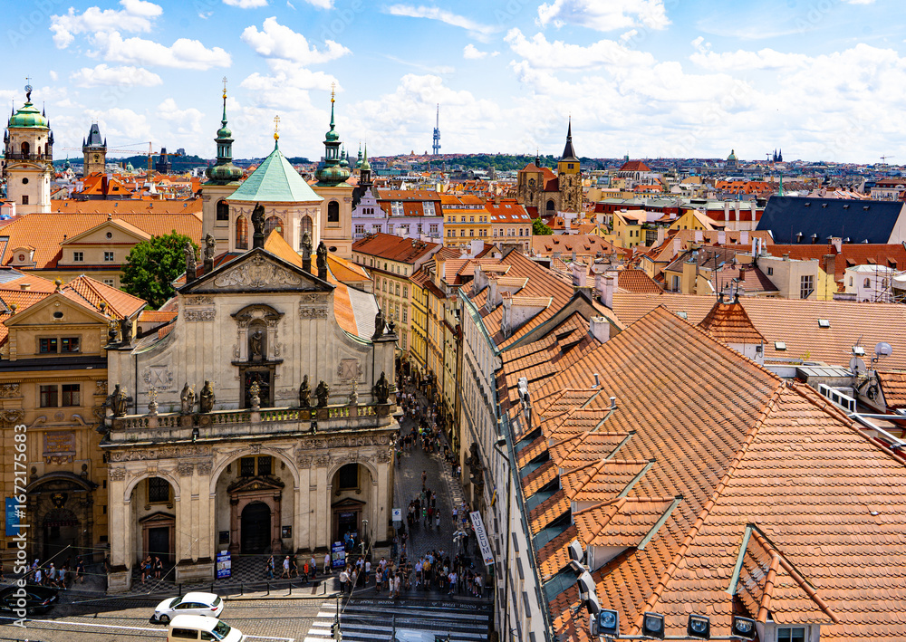 Obraz premium Panoramic view of old Prague with terracotta rooftops, cathedrals, towers, and the architectural lines of urban quarters.Prague,Czech Republic