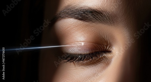 Close-up of female eye with light reflection on fluttered eyelid