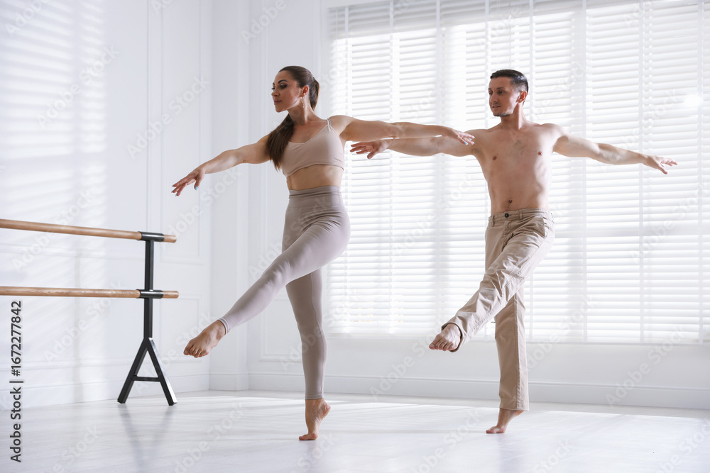 Naklejka premium Couple of professional dancers training in studio