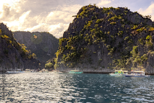Bangka tour boats at bottom of Large cliffs Coron Bay Coron Philippines 2025 