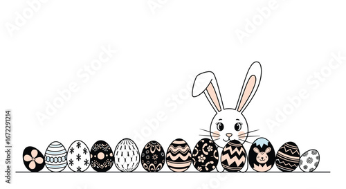 Adorable easter bunny peeking over a line of beautifully decorated eggs
