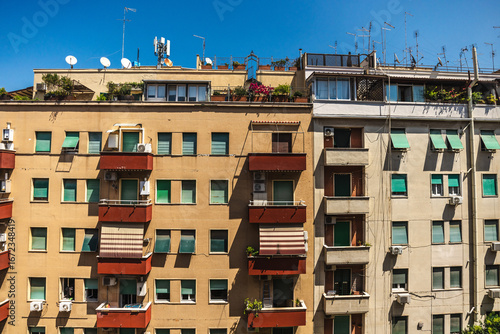 Photography Facade of residential apartment buildings with balconies, plants and antennas un
