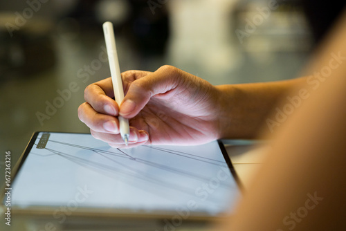 close up of the hand of a business woman holding an ipad at work
