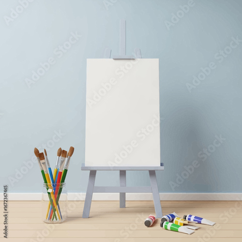 An empty canvas on an easel with art supplies.