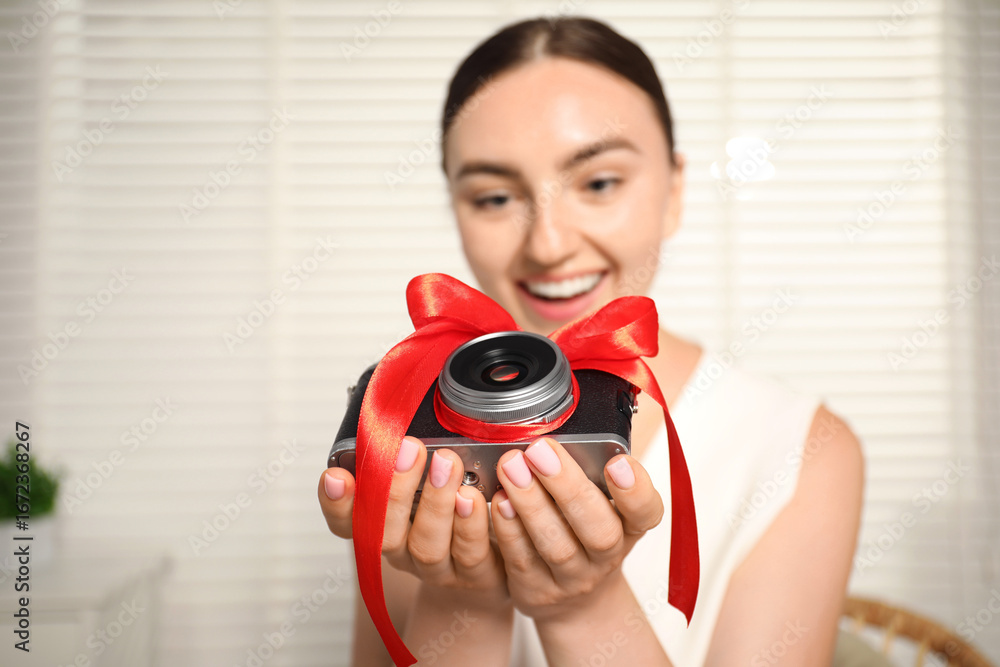 Fototapeta premium Dreams come true. Woman with new gifted camera at home, selective focus