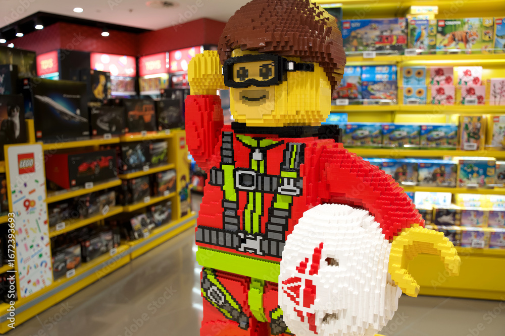 Obraz premium Rome, Italy - March 26, 2025: Colorful LEGO figure in a toy store, showcasing vibrant design and playful atmosphere with various toys in background