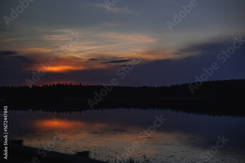 Wallpaper Mural A breathtaking sunset reflecting on a calm lake, surrounded by forested scenery, creating a peaceful and serene atmosphere perfect for relaxation. Torontodigital.ca