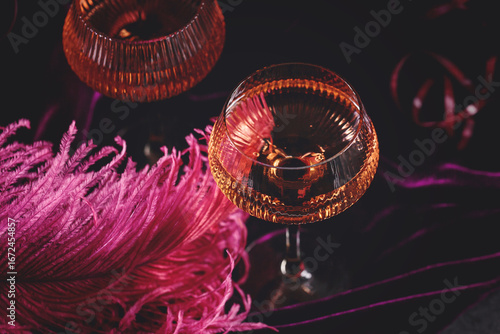 Obraz na płótnie Extravagant glamour background with glass of sparkling wine for love party at muffled light