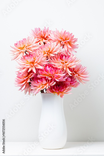 Elegant Bouquet of Pink and Coral Dahlias in a White Vase