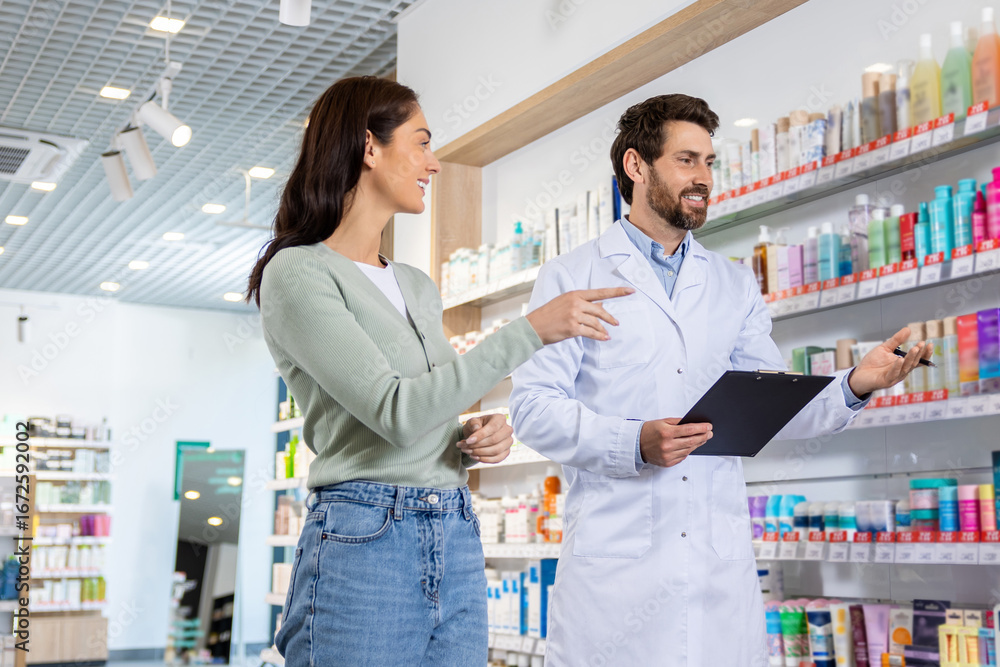 Fototapeta premium Male pharmacist talking to a woman and making notes